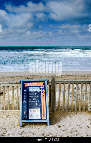 A sign encouraging people to pick up litter on Fistral Beach in Newquay in Cornwall. Stock Photo