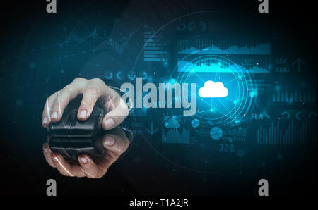 Hand using wireless mouse with cloud technology concept and dark background Stock Photo