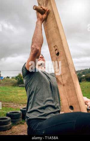 Participant in a obstacle course doing pegboard Stock Photo