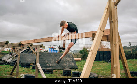 Participant in a obstacle course doing irish table Stock Photo