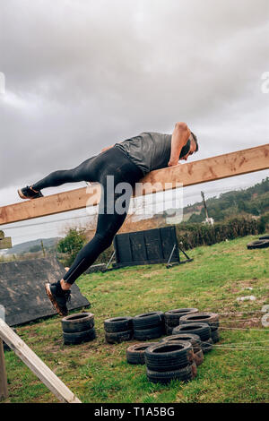 Participant in a obstacle course doing irish table Stock Photo