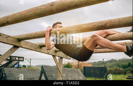 Participant in a obstacle course doing weaver Stock Photo