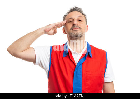 Serious male hypermarket or supermarket employee wearing red and blue vest touching temple with hand as obeying military concept isolated on white Stock Photo