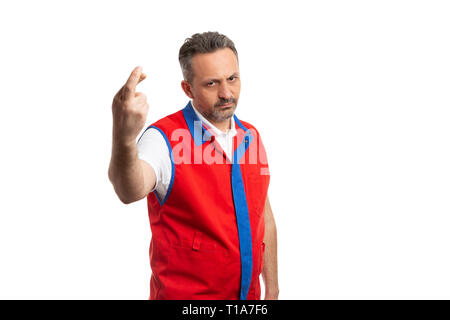 Male supermarket or hypermarket employee holding fingers crossed with angry expression as bad luck gesture isolated on white background Stock Photo
