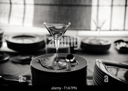 Empty ice cream cup elegantly arranged on plates, black and white photo. Stock Photo
