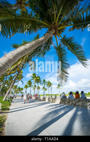 MIAMI - SEPTEMBER, 2018: Visitors stroll along on the beachfront promenade at Ocean Drive in South Beach. Stock Photo