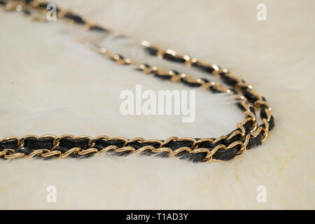 Photo of black handbag chain on the table. Stock Photo
