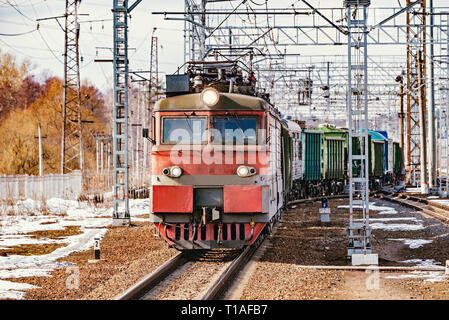 Long freight train approaches to the station. Stock Photo