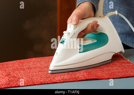 Laundry Services. Woman Hand Ironing Cloth On Ironing Board Stock Photo -  Alamy