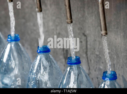 Customers get water at a source in Rome, Italy. Stock Photo