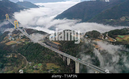 Beijing, China. 23rd Mar, 2019. This aerial photo taken on March 23, 2019 shows the Siduhe Bridge on the Shanghai-Chongqing Highway in Yesanguan Town of Badong County in Enshi Tujia and Miao Autonomous Prefecture, central China's Hubei Province. The Siduhe Bridge, built 90 meters high and 560 meters up from the valley bottom, forms a landscape in Enshi. Credit: Yang Shunpi/Xinhua/Alamy Live News Stock Photo