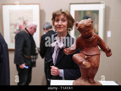 Paris, France. 24th Mar, 2019. Visitors look at artwork displayed in an exhibition marking the centennial of the Work-Study Movement in the China Cultural Center in Paris, France, March 24, 2019. A ceremony and a series of events were held here to mark the centennial of the Work-Study Movement. Starting in 1919, thousands of progressive young Chinese went to France, where they worked in factories in Paris, Lyon and Montargis to pay for their studies in the European country. Credit: Xinhua/Alamy Live News Stock Photo