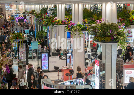 New York, USA. 24th Mar 2019. Cosmetics department in Macy's in Herald Square in New York during the 45th annual Macy's Flower Show, on opening day Sunday, March 24, 2019. Visitors flock to this year's show, given an extraterrestrial title and theme 'Journey To Paradisios', to enjoy over 5000 flowers in horticultural displays evoking a sci-fi trip into outer space. The show runs until April 7.  (© Richard B. Levine) Credit: Richard Levine/Alamy Live News Stock Photo