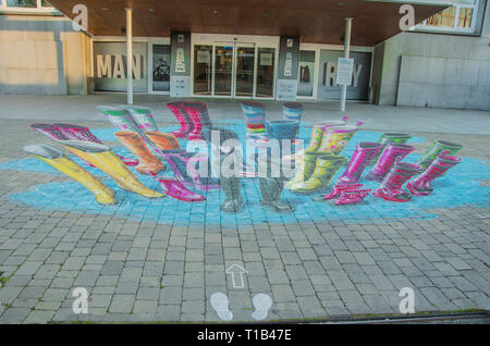 Madrid, Spain. 25th Mar 2019. 3D painting by Dutch artist Leon Keer in front of the door of Fundacion canal in the north of Madrid. The urban artist, one of the most outstanding in the international field, has made an ephemeral intervention with his 3D anamorphic graffiti painting. His work makes reference to the different audiences that benefit from the activities of the Foundation. This intervention may be contemplated for several months. Credit: Alberto Sibaja Ramírez/Alamy Live News Stock Photo