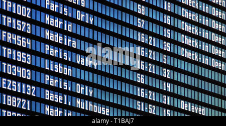 Flights information board at airport terminal Stock Photo