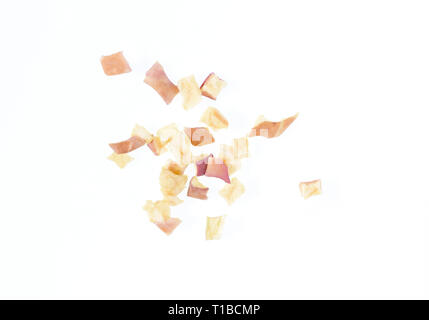 Close up photo image of cube sliced dry red apple isolated on white background, scattered pieces of dried fruit flakes, scattered dry red apple flakes Stock Photo