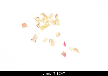 Close up photo image of cube sliced dry red apple isolated on white background, scattered pieces of dried fruit flakes, scattered dry red apple flakes Stock Photo