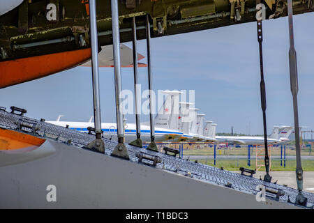Moscow regional. Airport Chkalovsky, 12 August, 2018: Airplane before loading cargo with open compartment. Other aircraft of air forces on background. Stock Photo