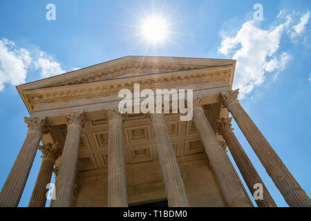 Front view of Maison Carree (square house), ancient building in Nimes, France, one of the best preserved antique Roman temple facades, low angle Stock Photo