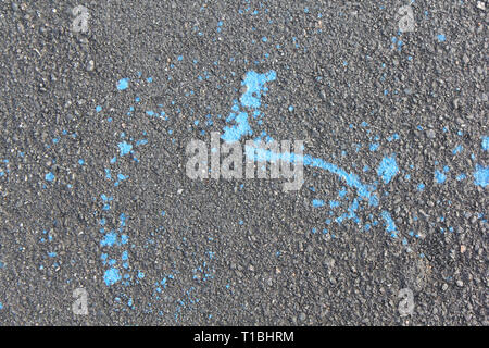 Blue paint is poured on asphalt. Abstract background Stock Photo