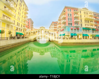 Wide angle view of Venice bridge at Qanat Quartier in the Pearl-Qatar, Persian Gulf, Middle East. Venetian bridge reflecting on canals of picturesque Stock Photo