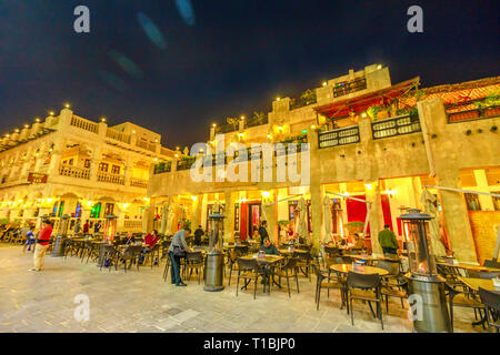 Doha, Qatar - February 17, 2019: historic buildings with traditional restaurants at Souq Waqif in central street, the old market in Doha, popular