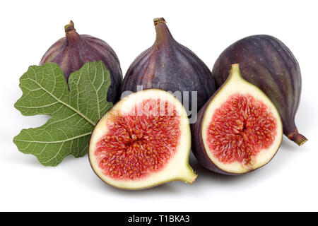 Fresh purple fig fruit and slices with leaf isolated on white background Stock Photo