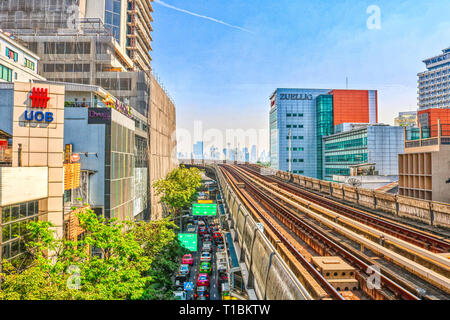 this unique image shows the skytrain bts trail in bangkok thailand and you can see the skyline of the city in the background Stock Photo