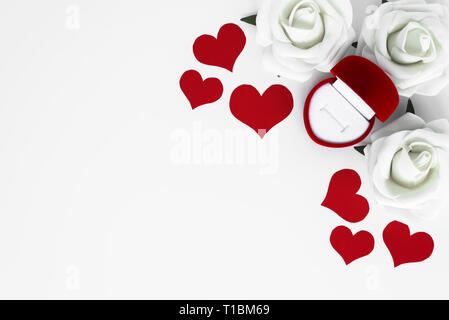 Top view of arrangement from red hearts, white roses and open empty decorative box for engagement ring, all on white background with copy space. Happy Stock Photo