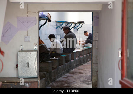 Muslims wash their feet before praying in The New Mosque,, Kashgar, Xinjiang, China. Stock Photo