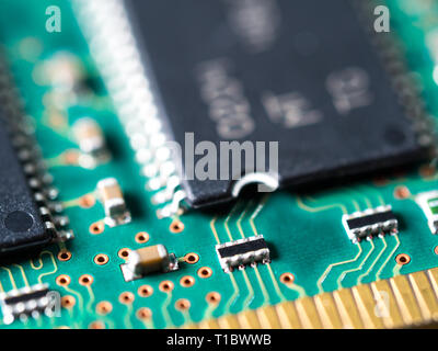 close-up of a circuit board with integrated circuits, resistors, and capacitors. Stock Photo