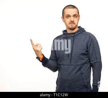 Man in hoodie pointing on something with shoked face Stock Photo