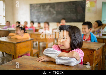 Elementary age school children attending class in a rural classroom in the Guangxi region of central southern China. Stock Photo