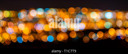 Blurred defocused city lights, Quito city, Ecuador. Abstract conceptual pattern as a banner expressing night city life, as wallpaper or background. Stock Photo