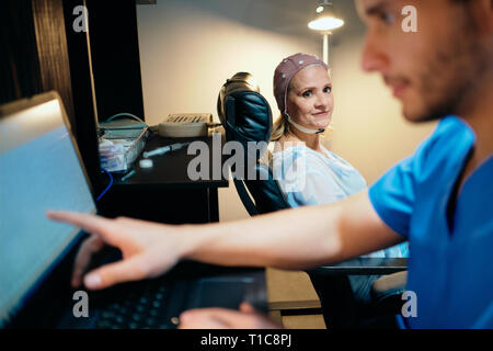 Doctor Doing Brain Medical Exam On Old Woman In Hospital Stock Photo