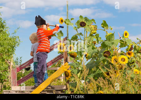 Kids playing pirates in urban gardens at Tempelhofer field, once airport, now a public park in Berlin, Germany Stock Photo