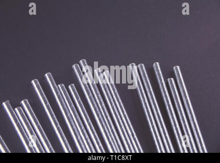 Drinking paper straws for summer cocktails on black background. Top view. Stock Photo