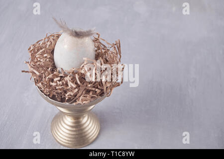 Easter egg on the table with feather Stock Photo