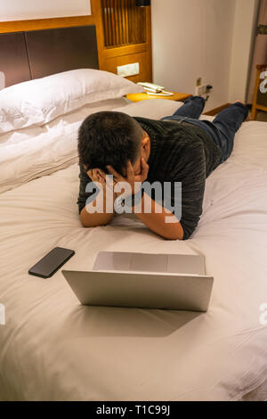 Depressed young Asian man lying in bed cannot sleep from insomnia Stock ...