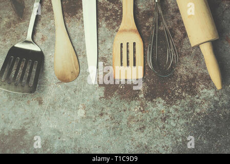 Kitchen Utensils against Grunge background Stock Photo