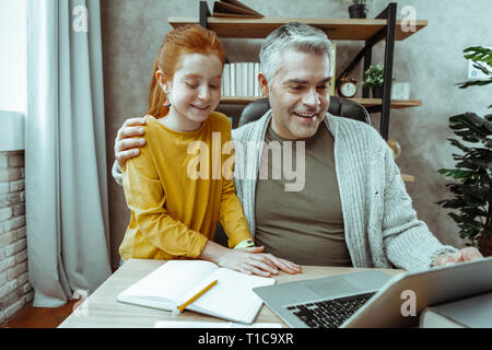 Joyful nice father and daughter smiling together Stock Photo