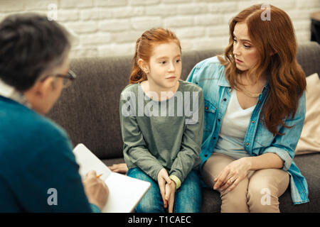 Nice young woman looking at her daughter Stock Photo