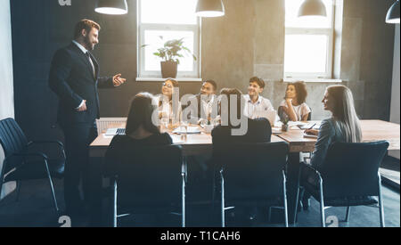 Business colleagues discussing project plans in office Stock Photo