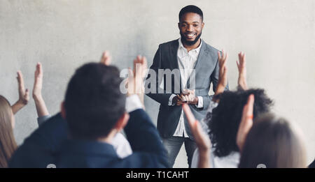 Business training. Audience applauding to speaker after seminar Stock Photo