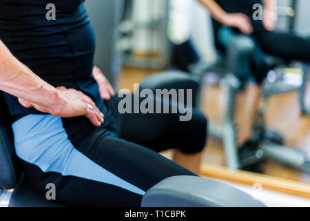 50 yr old female bodybuilder training in a gym Stock Photo
