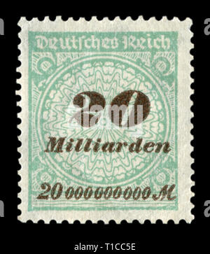 German historical stamp: Green postage stamp with overprint with a face value of 20 billion marks, hyperinflation, the economic crisis in Germany Stock Photo