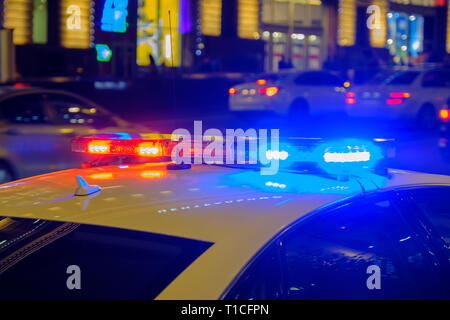 Red and blue flashing lights on police car in the night. Stock Photo