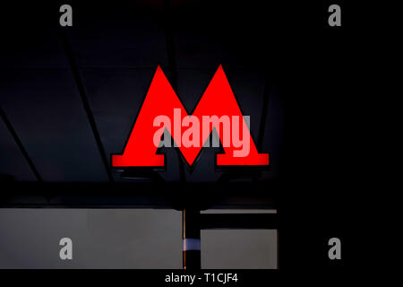 Moscow, Russia, February, 12, 2018. Emblem, the red letter 'M' of the Moscow metro on dark background. Stock Photo