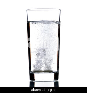 Two fizzy pills in the glass of water. Isolated on a white background. Stock Photo
