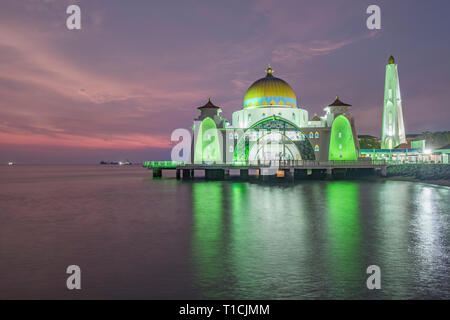 Sunset over Melaka Straits Mosque, located in Malaysia, and built using the mix of Middle Eastern and Malay craftsmanship, looks like a floating struc Stock Photo
